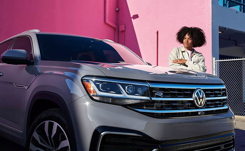 Woman beside a Volkswagen vehicle image